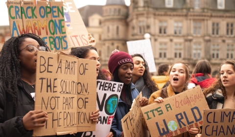 Group of children protesting with banners on climate change.