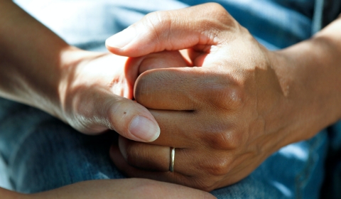 Photograph of two hands being held